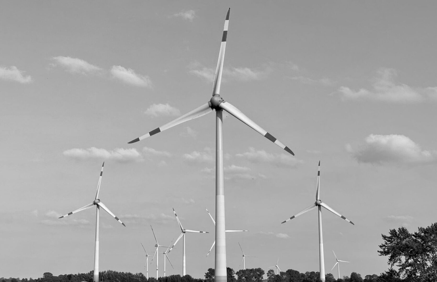 A black and white photo of wind turbines.